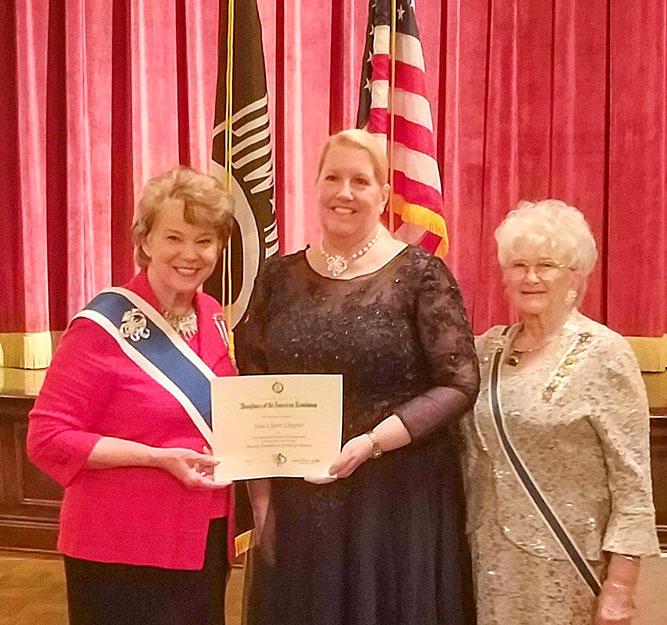 three DAR members at an awards ceremony, one is receiving an award