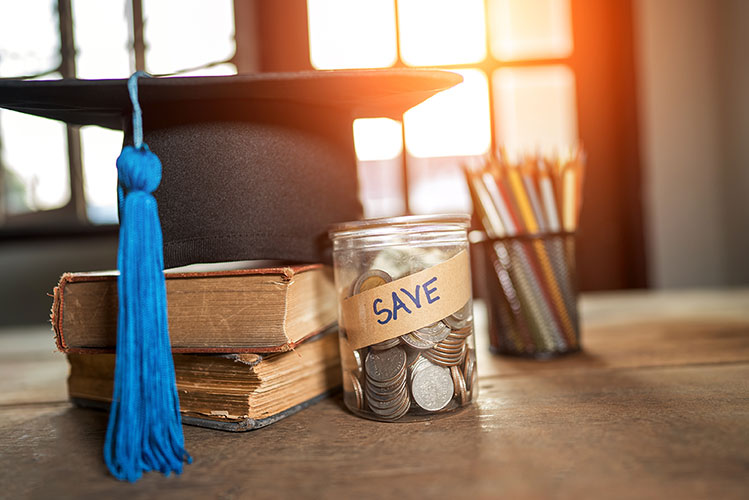 savings from scholarships in a jar with graduation cap